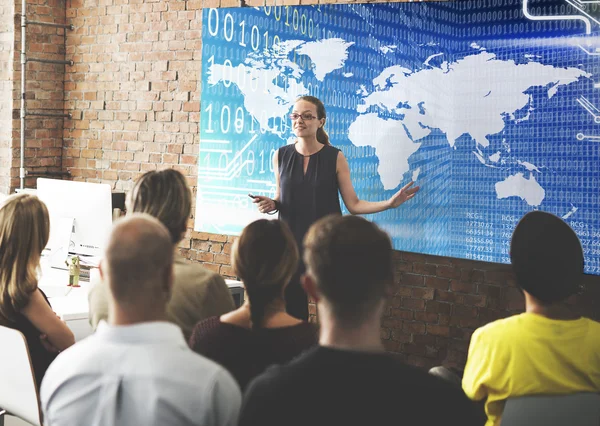 People at conference with global map