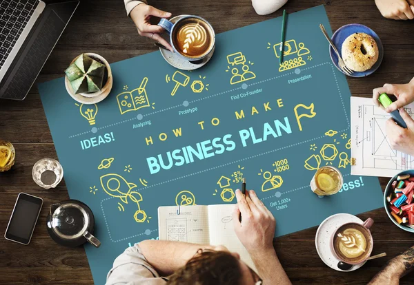 Table with poster with Business Plan