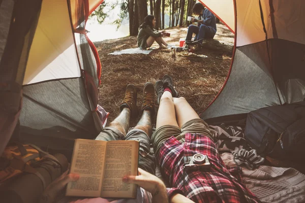 Friends relaxing in tent