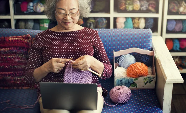 Portrait of senior woman knitting