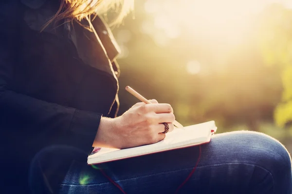 Travel girl making notes