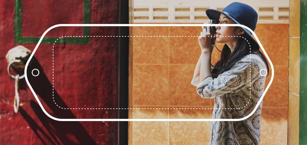 Girl in black hat with camera