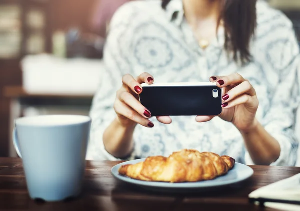 Girl Photographing food in cafe