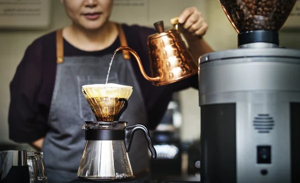 Barista making coffee in cafe