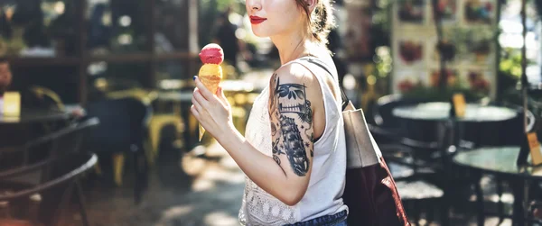 Beautiful girl with tattoos and ice cream