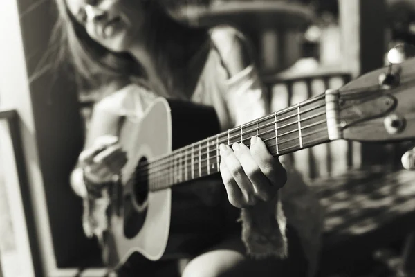 Cute Girl playing on Guitar outdoors