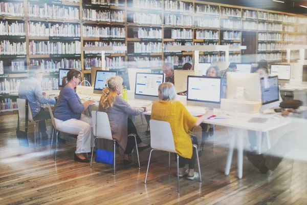 Senior people working with computers