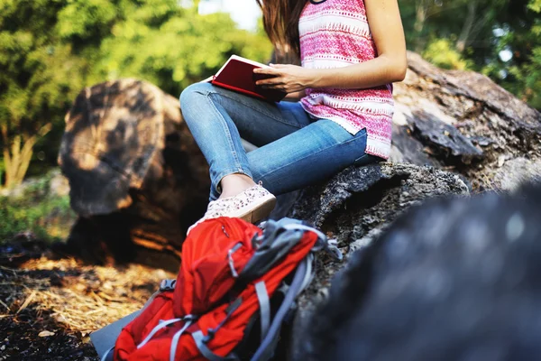 Woman writing notes in nature