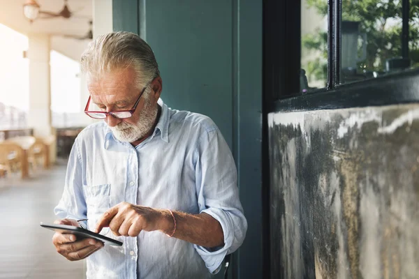 Casual Senior Man using Tablet