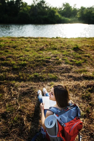Woman writing notes in nature
