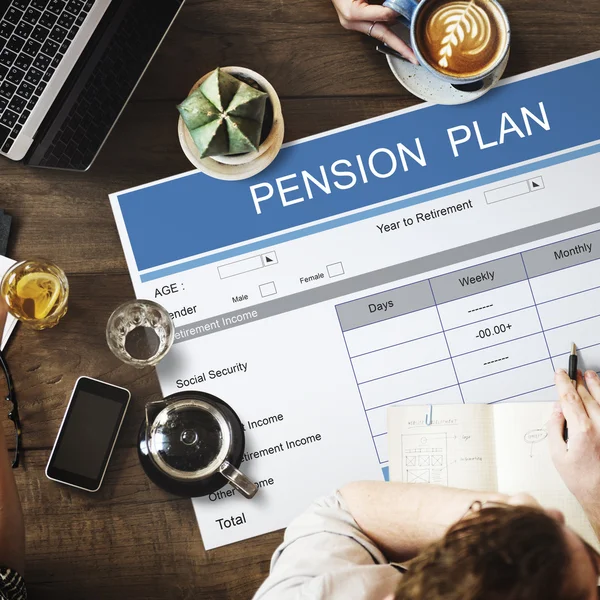 Table with poster with pension plan concept