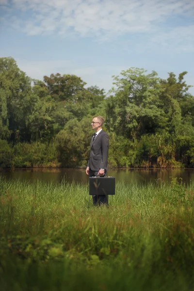Businessman in suit at nature