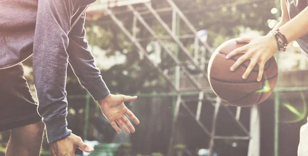 Sportsman teaching boy play Basketball