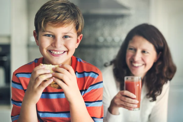 Happy mom with son at home kitchen