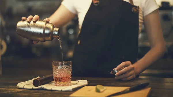 Woman barista making cocktail