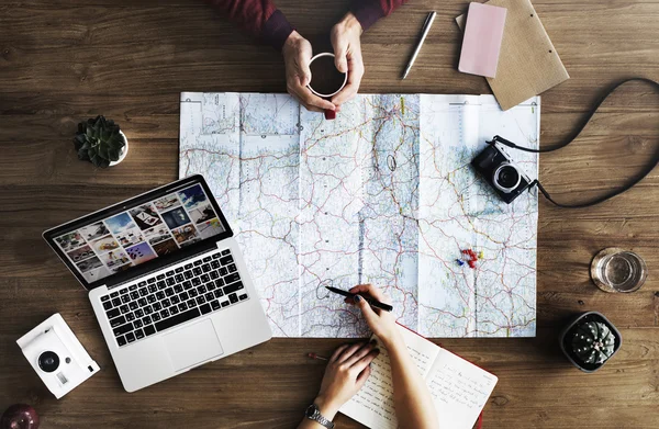 People sitting at desk with map