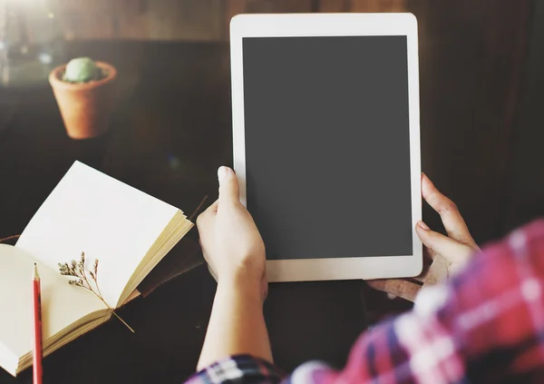 Person with tablet on hands