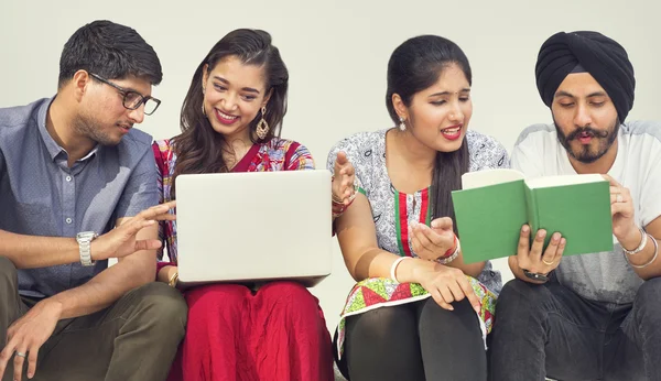 Indian students with laptop and book