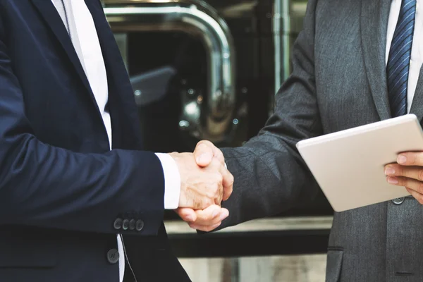 Businessmen Handshake after Success Deal