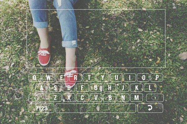 Woman legs on grass in red shoes