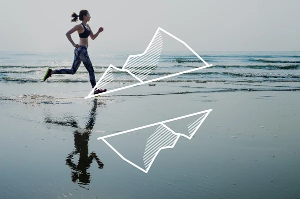 Woman in leggings running on beach