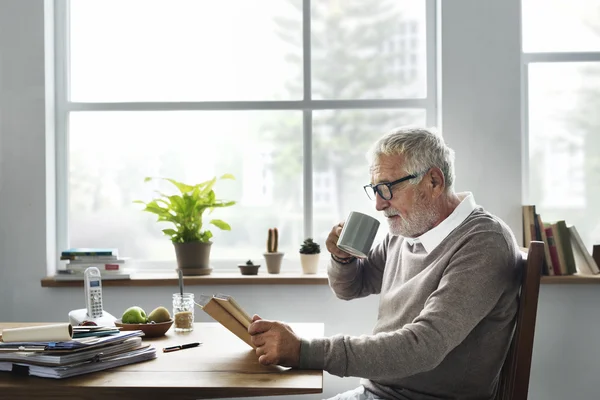 Senior Man reading book