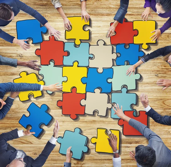 Business People Forming Jigsaw Puzzle