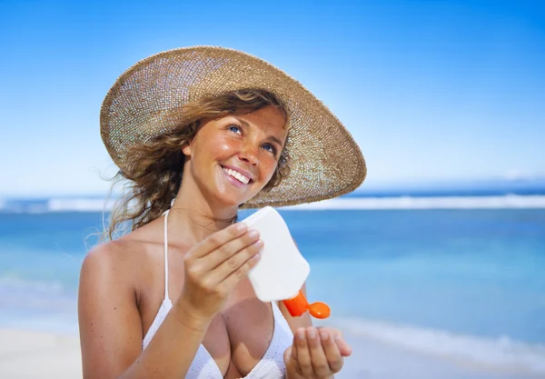 Woman with sun protection lotion