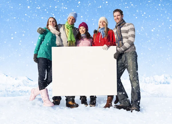 People holding blank placard on snow