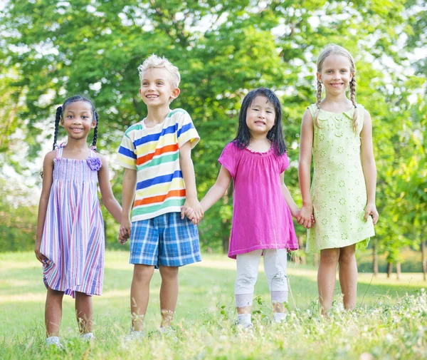 Children holding hands in the park