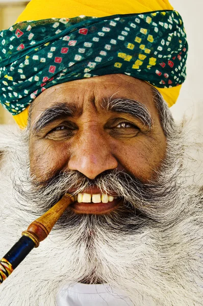 India man smoking pipe