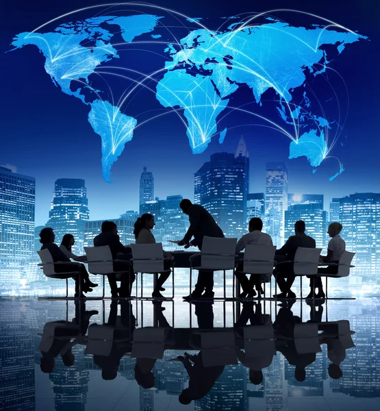 Business people and world map above