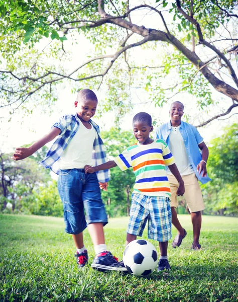 Father and Sons Playing Soccer