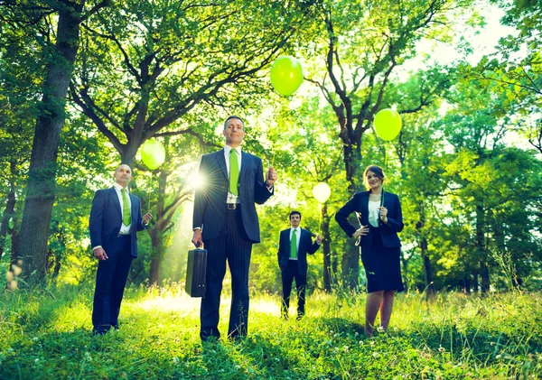 Business people holding balloon