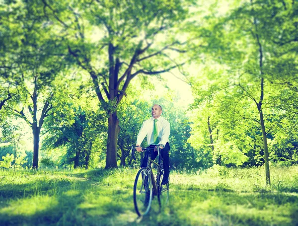 Conservative businessman riding bike