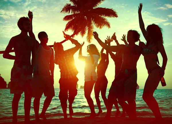 People celebrate at a party on a tropical island