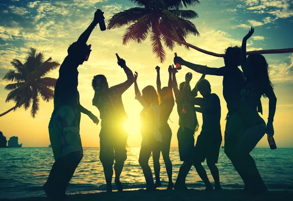 People celebrate at a party on a tropical island