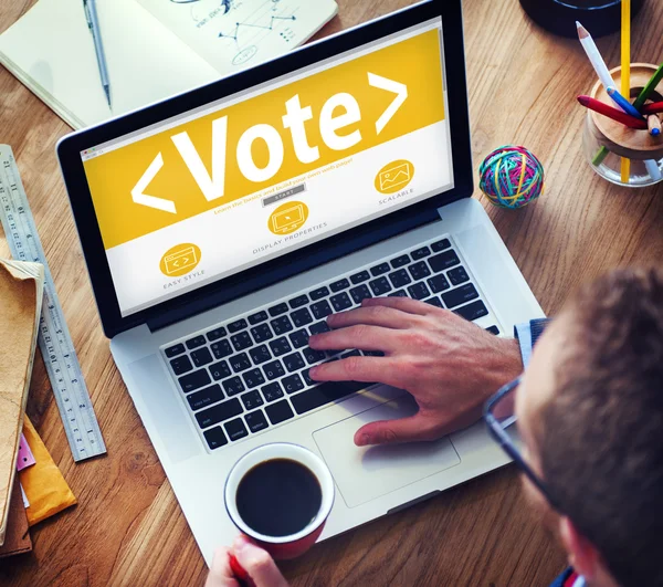 Man working on laptop with Vote