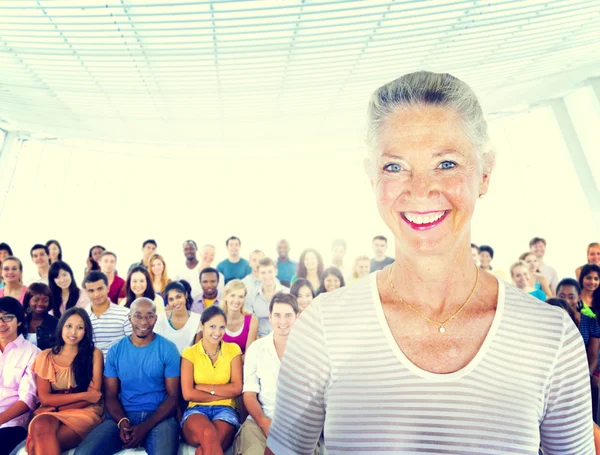 Senior smiling and standing out from crowd