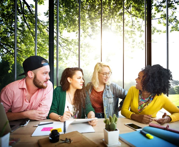 Diverse college students brainstorming in classroom