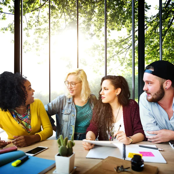 Diverse college students brainstorming in classroom