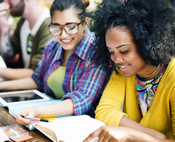 Diverse college students studying in classroom