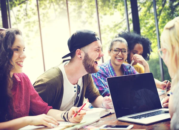 Diverse college students brainstorming in classroom