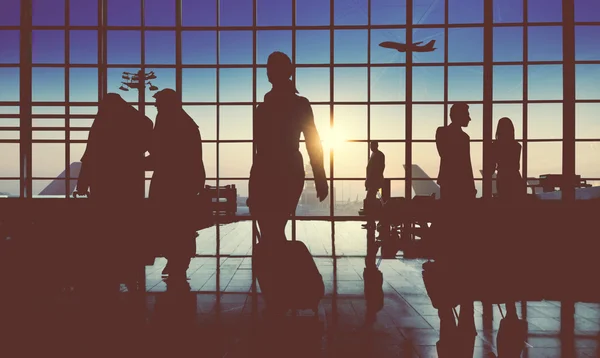 Silhouettes of business people in the airport