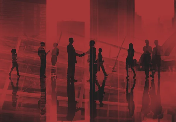 Silhouettes of business people shaking hands