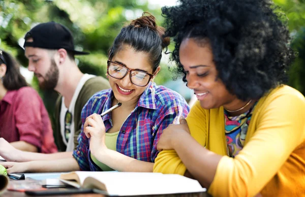 Diverse college students studying in classroom