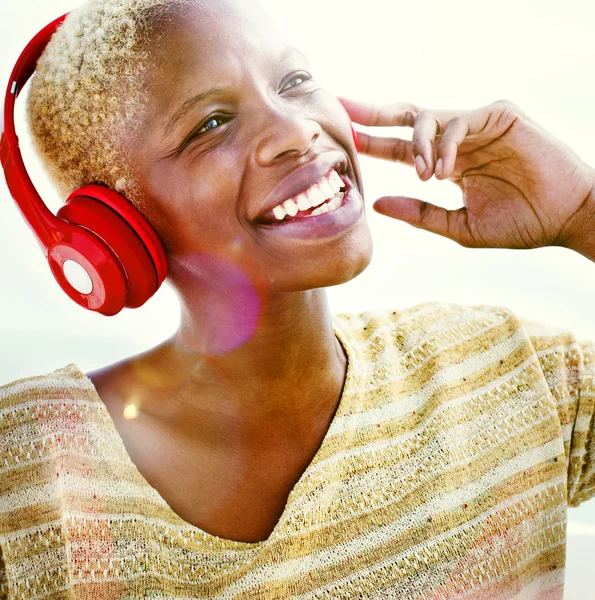African Woman in Headphones Listening Music Concept