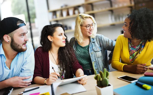 Diverse college students brainstorming in classroom