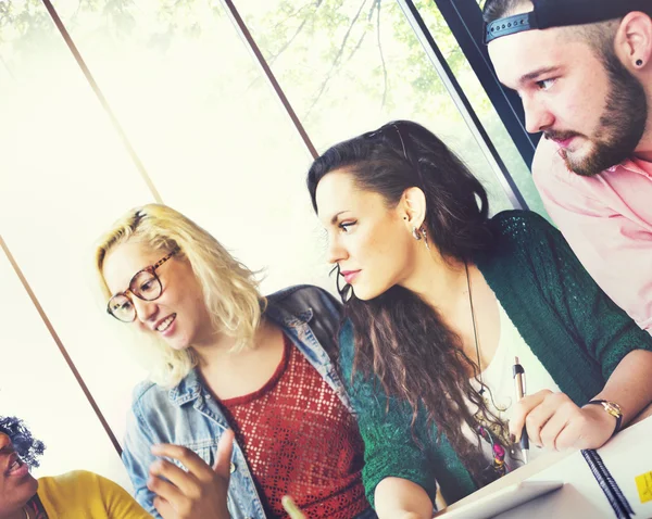 Diverse college students brainstorming in classroom