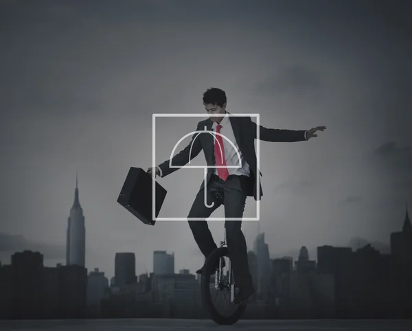 Businessman riding one wheel bicycle